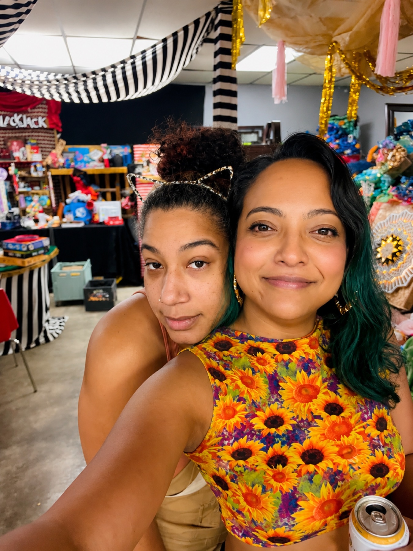 Art Night · two friends in the decorated studio, gold streamers overhead