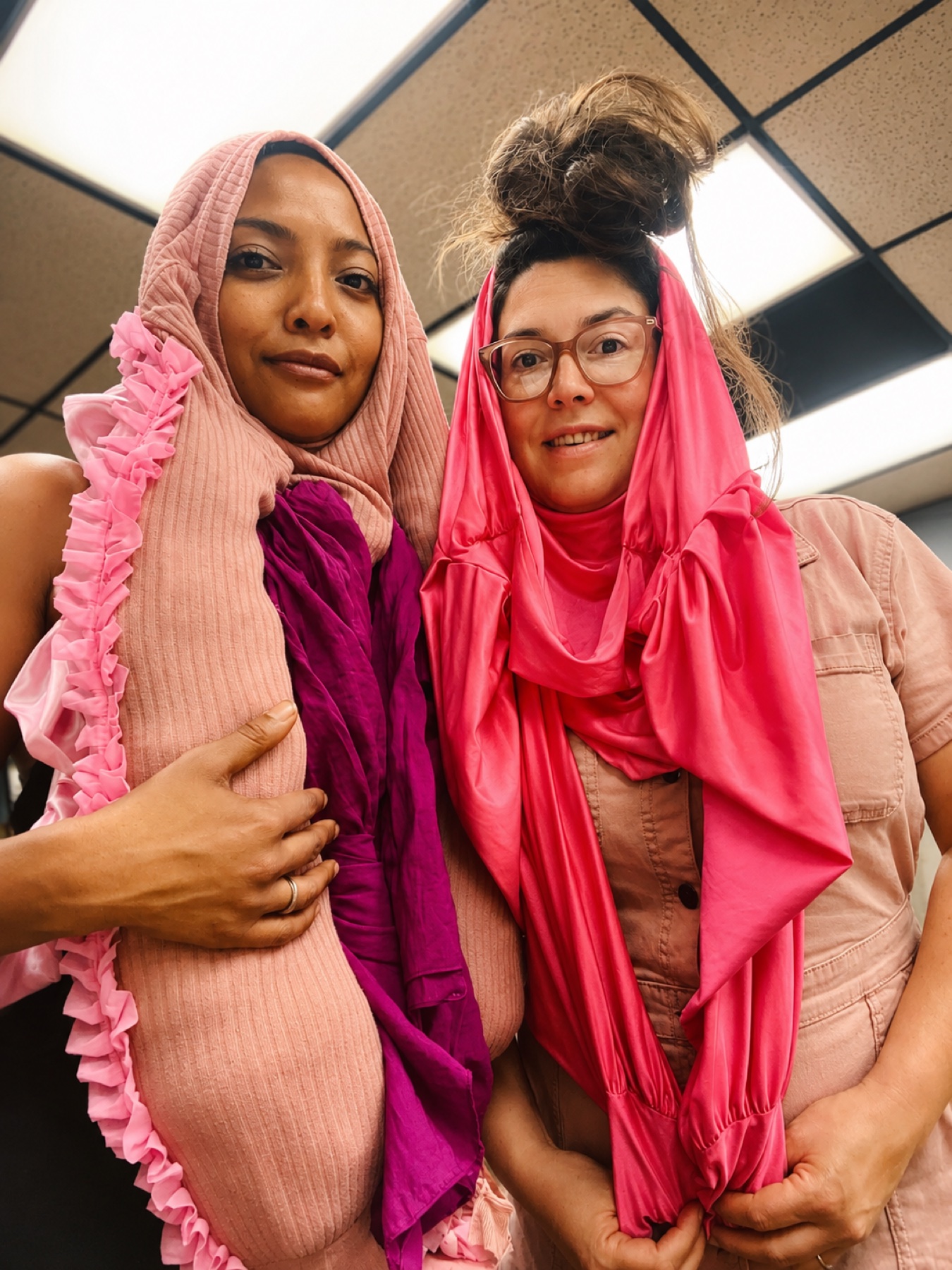Art Night · two makers wrapped in the pink costume pieces they just built