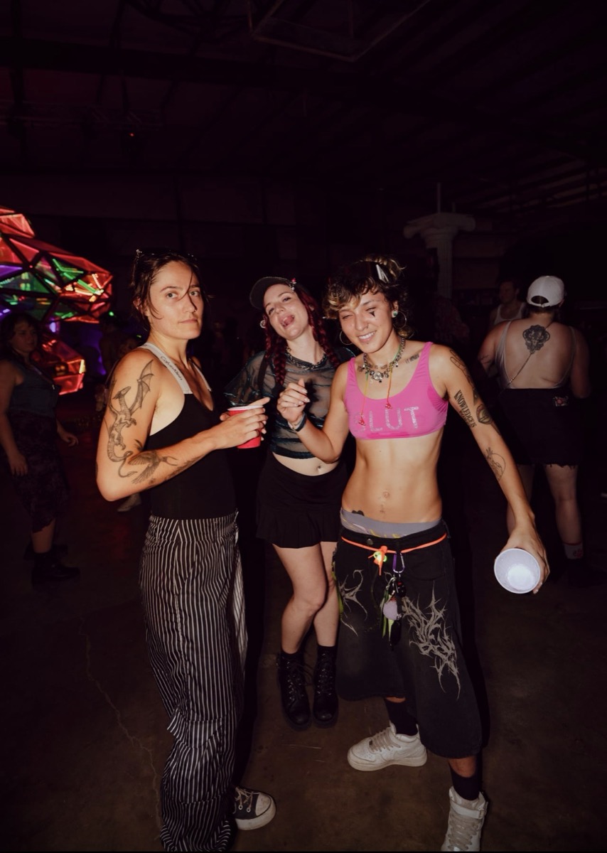 Friends on the floor in front of the glowing geodesic sculpture