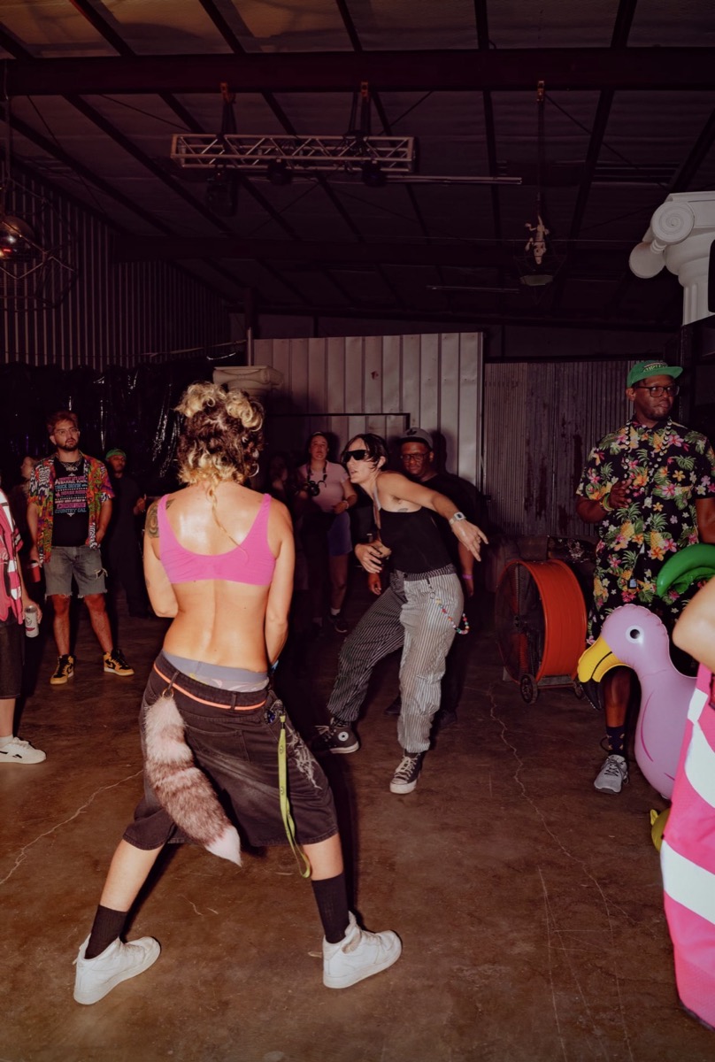 A dance circle opens up on the warehouse floor