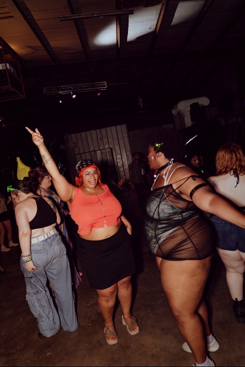Dancers mid-move with hands in the air