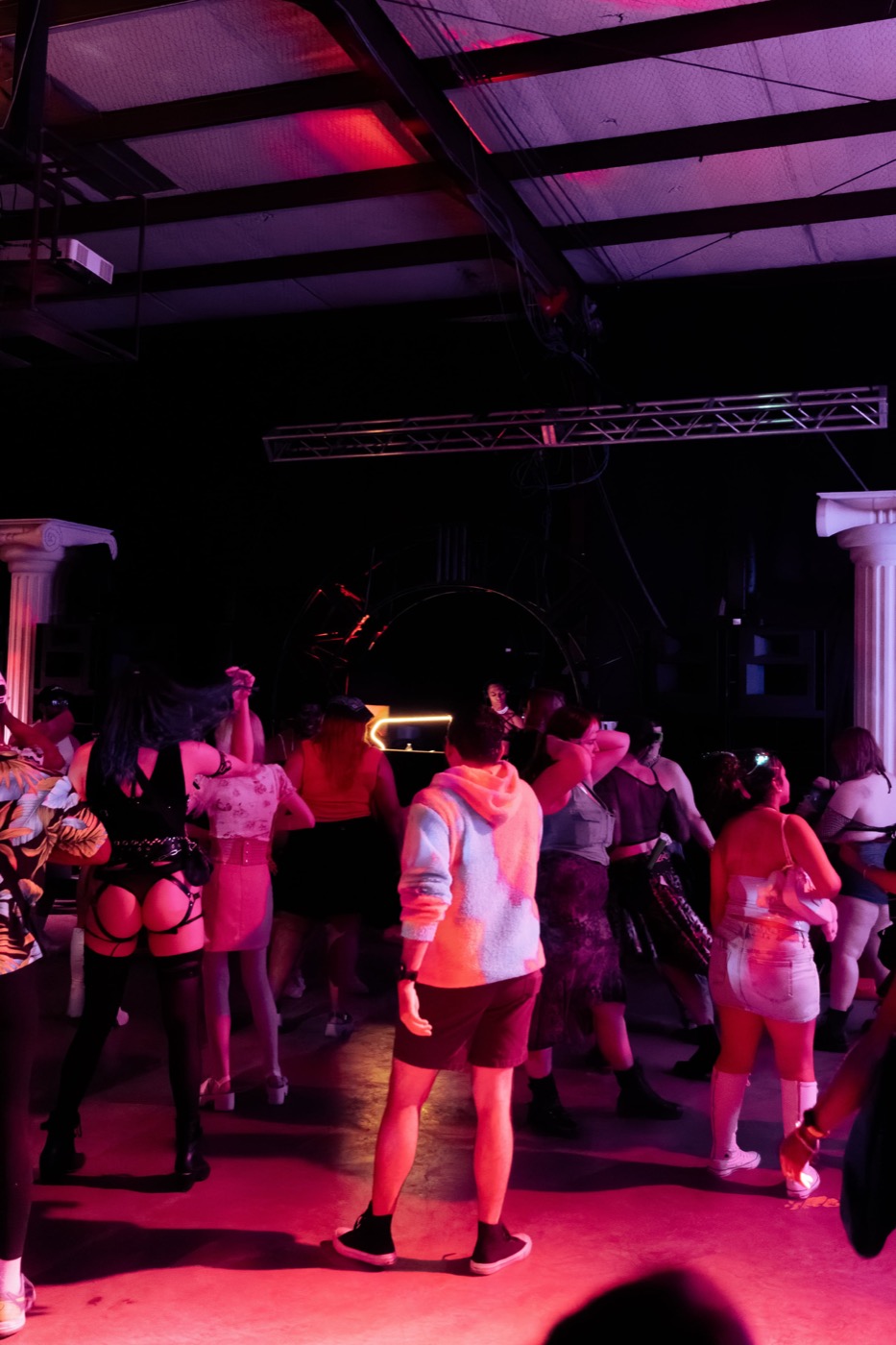 The Babestock dance floor glowing pink under the warehouse rafters, full of people