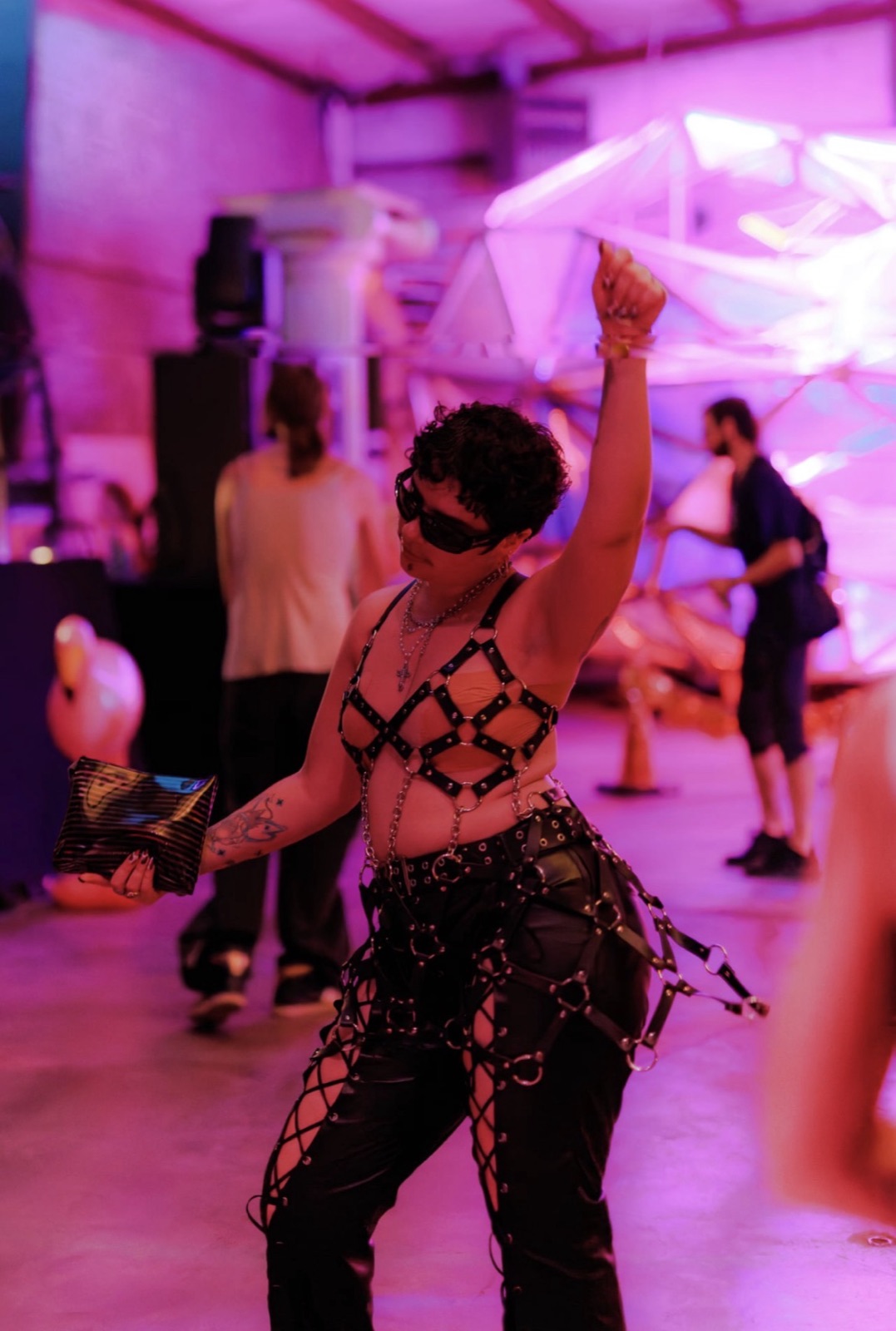Babestock Rave · a dancer in harness and chains under the pink lights
