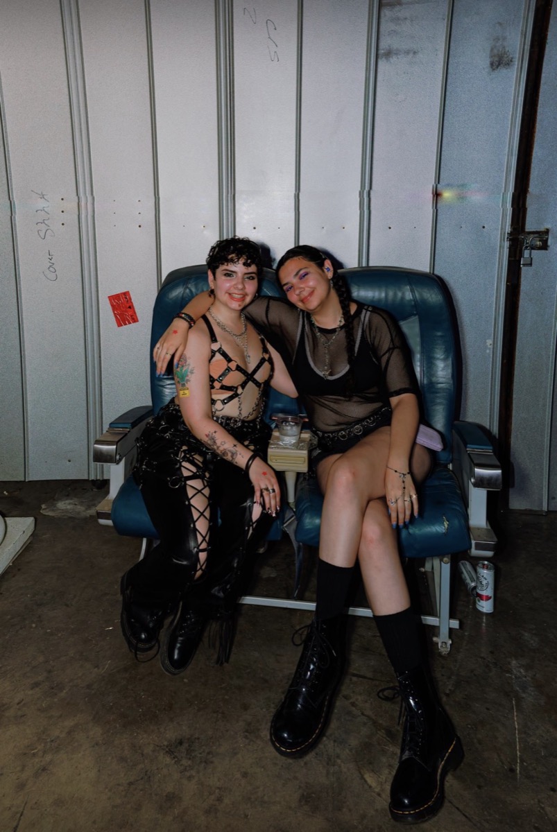 Two friends cozied up in the salvaged airplane seats