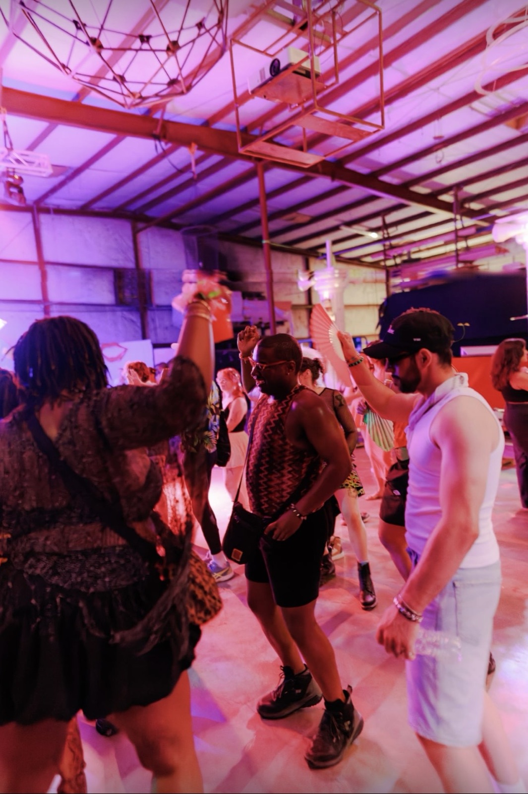 The Vector Collective dance floor glowing pink under the warehouse rafters