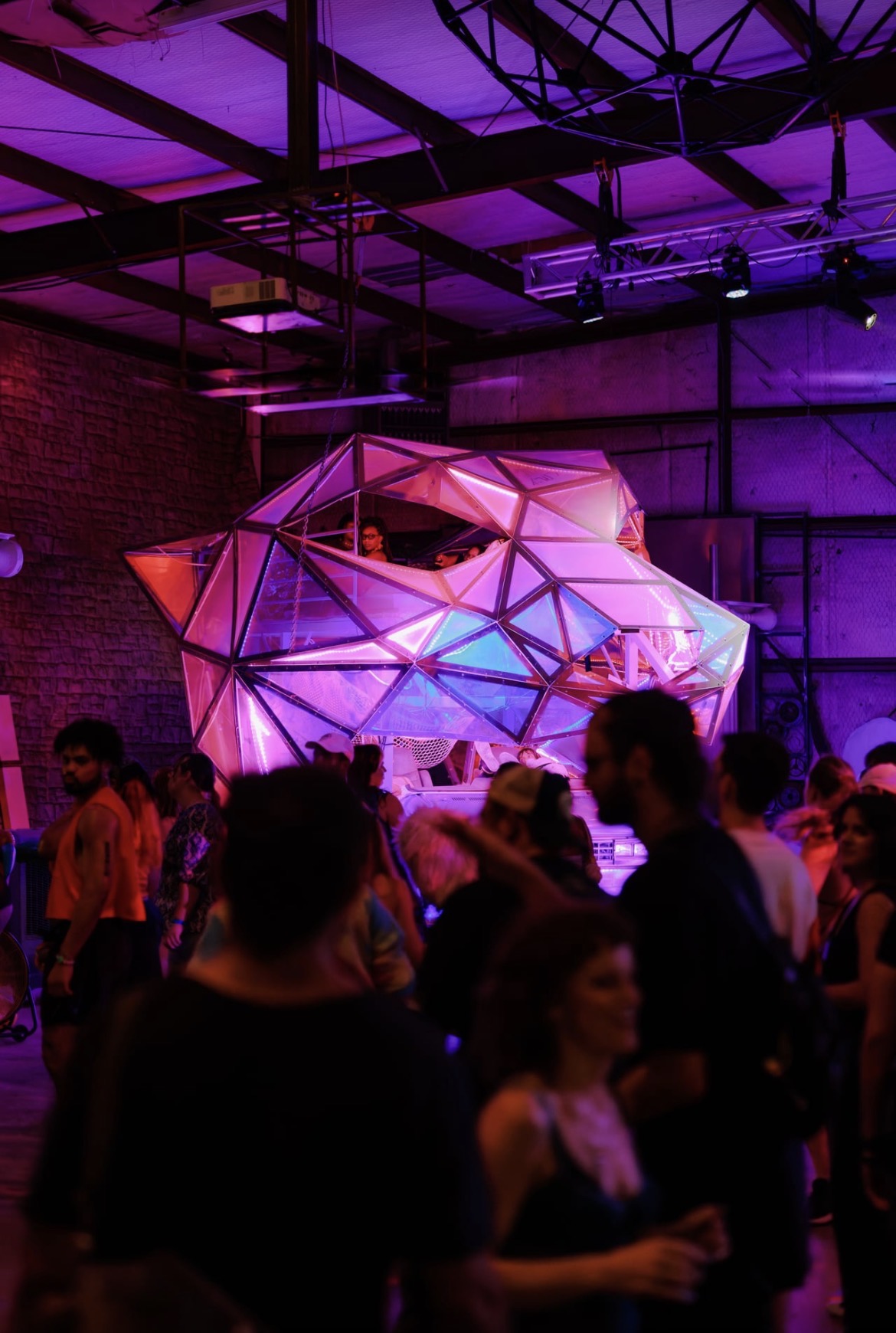 Vector Collective · DJs playing inside the glowing geodesic booth above the crowd